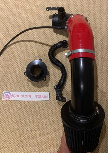 Audi S1 intake seen here with a red silicone hose, Black alloy pipe and the optional PRORAM filter. This picture also includes a turbo muffler delete